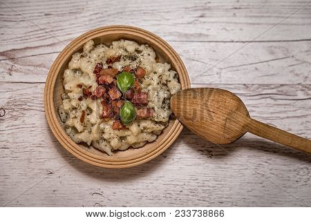 Slovak Traditional Potato Gnocchi With Sheep Cheese On A Wooden Table Laid On A Table