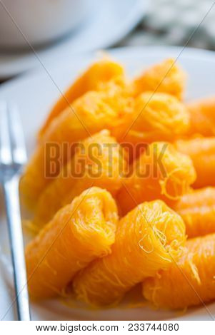 Close Up Of Thai Traditional Dessert, Rolled Egg Yolk Thread. Thai Style Fios De Ovos.