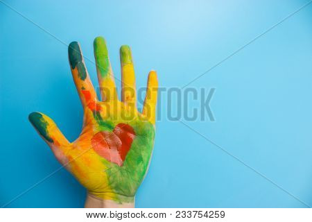 Hand In Colorful Paint With Red Heart