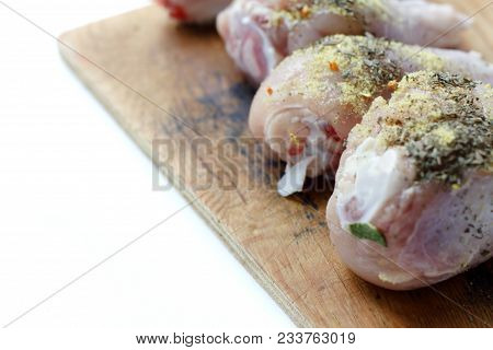 Chicken Drumsticks On A Wooden Board. On White, Isolated Background.top View. Flat Lay. Fresh Chicke