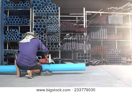 Worker In Sawing Pvc Pipes,industry Construction Process To Prepare Cutting Of Blue Tube For Water S