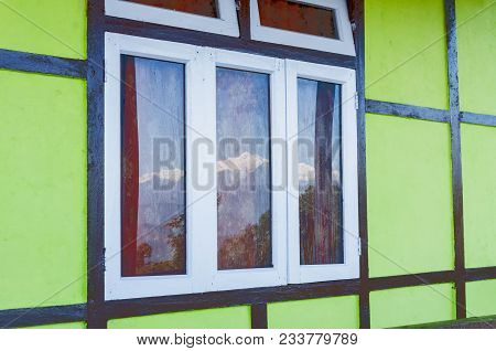 Beautiful Reflection Of Snowy Mount Kanchenjungha On Glass Window , Wet With Dew Drops. Image Of Him