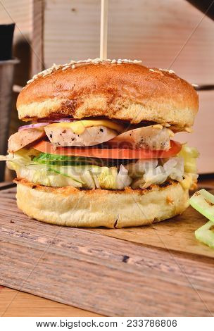 Top View Fresh Homemade Burger With Chicken, Salad, Cheese, Onion, Cucumber, Tomato, Sause And Dark 