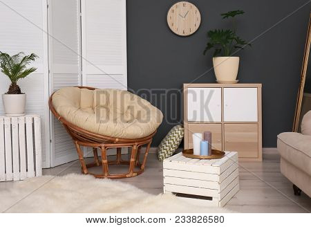 Tropical Plants With Green Leaves And Papasan Chair In Room Interior