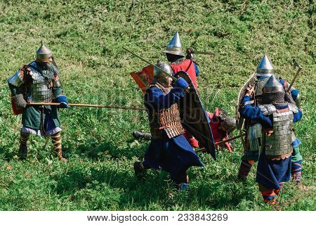 Luh, Russia - August 27, 2016: Reconstruction Of Medieval Battle Of Knights In Armor And Weapons At 