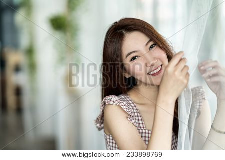 Portrait Of Beautiful Young Asian Woman Model With Pink Dress Wearing Sitting And Smiling Brightly O