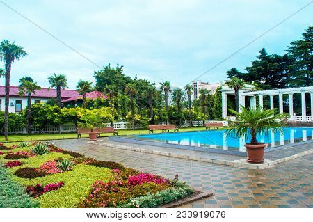 Walking Public Path, Benches, Arches, Trees And Flowers, Swimming Pool In The City Park
