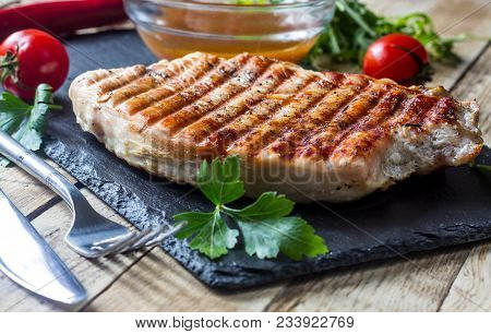 Grilled Turkey Fillet With Vegetables On On A Black Slate On Ristic Background. Selective Focus