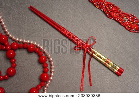 Red Japanese chopsticks on crey background