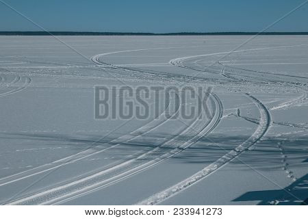 Winter Landscape, Snowmobile Tracks On The Frozen Lake
