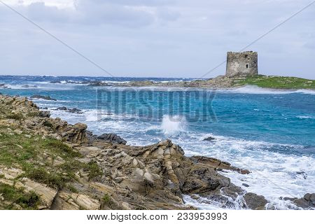 A View Of The The Torre Della Pelosa Tower And The Isola Piana Island In The Background In Stormy We