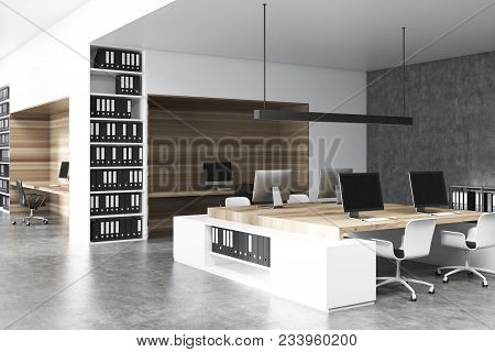 Modern Office With A Concrete Floor, Bookcases And Rows Of Computer Tables. Original Workspece Devit