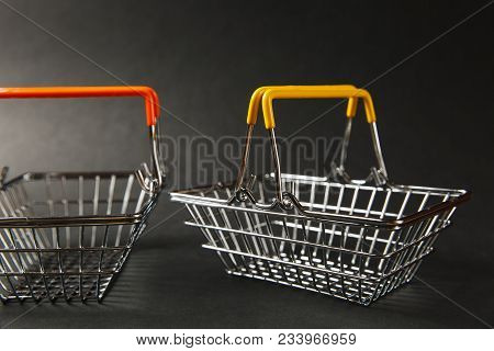 Close Up Of Two Grocery Basket For Shopping In Supermarket With Raised Handles And Orangeand Yellow