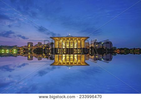 Mirror Reflection Of Beautiful Iron Mosque During Blue Hour.