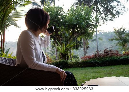 A Beautiful Young Woman Drnking Tea And Relaxing In The Morning