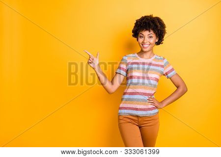 Photo Of Positive Fun Nice Pretty Toothy Beaming Girl Pointing At Empty Space In Striped T-shit Oran
