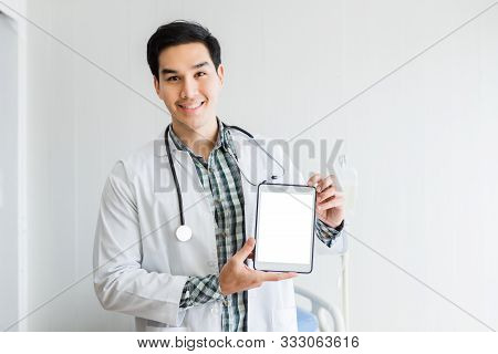 Asian Young Man Doctor Therapeutic Advising With Positive Emotions  Holding Up And Showing Digital T