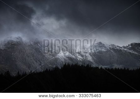 Stunning Dramatic Landscape Image Of Snowcapped Glyders Mountain Range In Snowdonia During Winter Wi