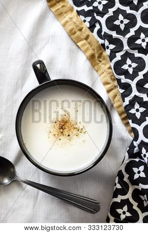 Cauliflower Soup (creme Du Barry) In Black Bowl On White Background With Black And White Cloth. Fren