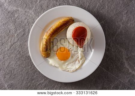 Arroz A La Cubana.typical Cuban Rice With Fried Banana And Fried Egg On A Plate On Gray Background. 