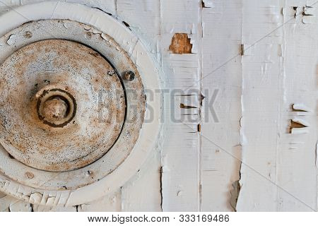 Grungy White Wood Panel And A Round Aged Metal Object. Fragment Of An Abstract Vintage Installation