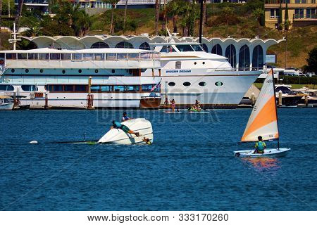 August 25, 2019 In Newport Beach Harbor, Ca  People Sailing And Capsizing On Dinghy Sail Boats In Th