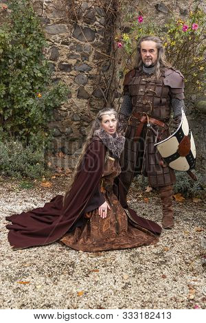 Couple Posing Robed In Beautiful Medieval Clothing