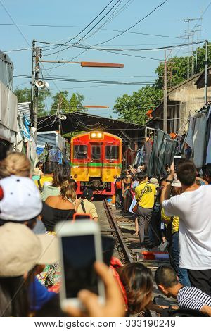 2019 July 15. Samut Songkhram Thailand. Clowd Of People Taking A Photo Of A Train While Passing Tala