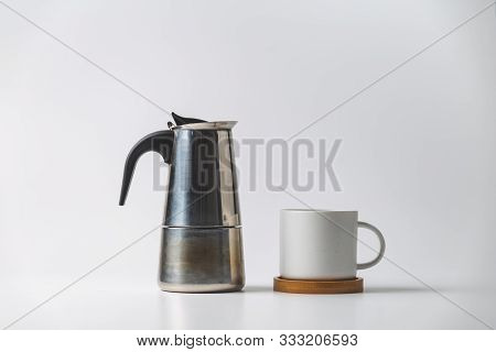 Close Up Of A Coffee Cup And A Moka Pot Isolated