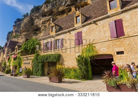 La Roque-Gageac, Dordogne, France - August 13, 2019: People visiting La Roque-Gageac scenic village on the Dordogne river, France