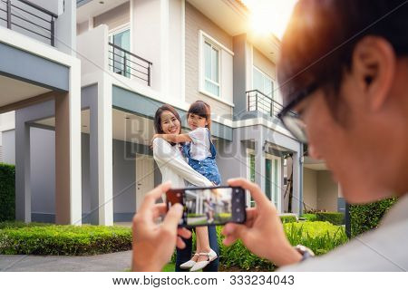 Beautiful Family Portrait Smiling Outside Their New House With Sunset, This Photo Canuse For Family,