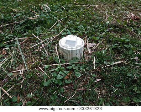 White Plastic Sewer Cleanout Pipe In Yard With Grass