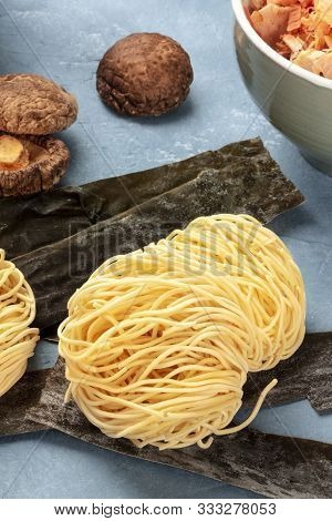Udon Noodles, Close-up With Dried Sea Vegetable Kelp, Shiitake Mushrooms, And Katsuobushi Tuna Flake