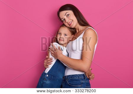 Happy Beautiful Young Mother Hugging Her Little Cheerful Daughter, Attarctive Woman Posing With Her 