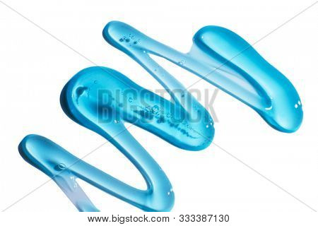 Squeezed cosmetic clear cream gel texture Iisolated on white background. Close up photo of transparent drop of skin care product. High Quality transparent gel with bubbles closeup on white background