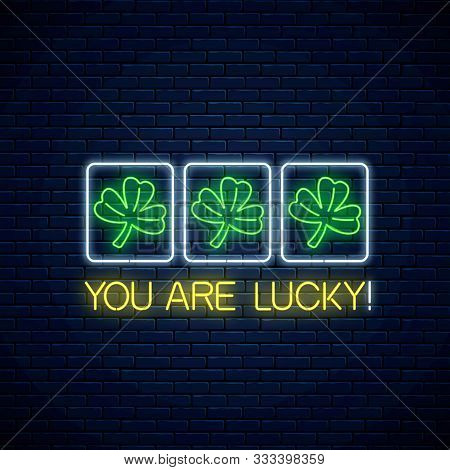 You Are Lucky - Glowing Neon Motivation Phrase With Three Clover Leaves On Slot Machine. Slot Machin