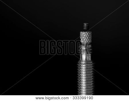 Macro Image Of A Presta Bicycle Valve Against A Black Background