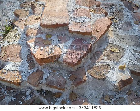 The Restored Wall Of The Building Of Roman Times. Sunlight Accentuates The Warm Brown-red Shades Of 