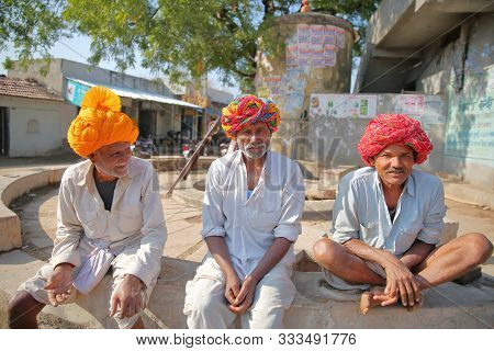 Bundi, Rajasthan, India - December 09, 2017: Portrait Of Three Men Dressed In White With A Colorful 