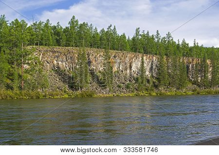 High Steep Rocky Bank Of The Oka Sayan River. East Sayan, Buryatia, Siberia, Russia.