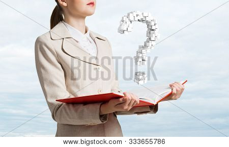 Attractive Woman Holding Open Notebook With Question Mark From Cubes. Business Consultation And Lega
