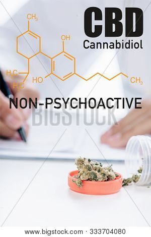 Selective Focus Of Container With Medical Cannabis Near Doctor Writing Prescription And Non-psychoac