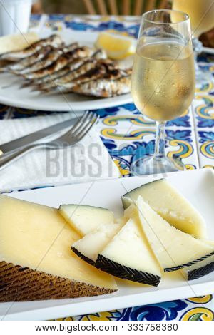 Andalusian Food, Chees En Espeto, Malaga Style Fish On Stick Barbecue Served With Glass Dry Fino She