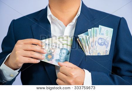 Money In China Hold On Hand Business Man And Money In Vietnam Dong, Vnd, Wearing A Blue Suit  Cny, P