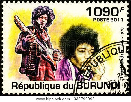 Moscow, Russia - November 12, 2019: Stamp Printed In Burundi Shows Portrait Of Jimi Hendrix With Gui