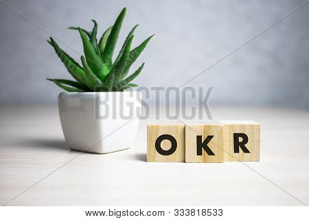 Okr Word Written On Wood Block. Abbreviation Of Objective Key Results Text On Wooden Table For Your 