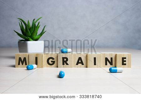Stock Photo The Word Migraine Along With Paracetamol Tablets