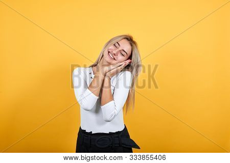 Gorgeous Young Caucasian Girl Making Sleep Gesture In Dorable Expression Wearing Pretty White Shirt 