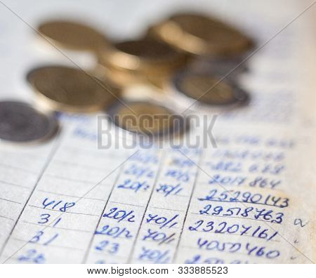 Hand-written Calculations And Coins. Bookkeeping (accounting). Economy. Financial Themes. Money Savi