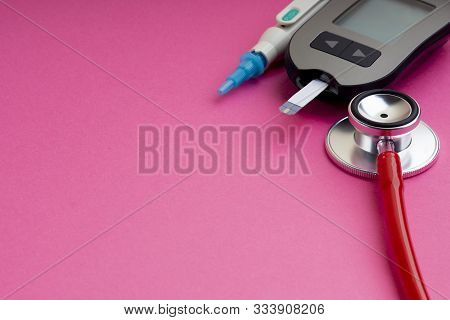Diabetes Concept. Syringe, Glucometer Or Glucose Meter And Stethoscope On Pink Background. Healthcar